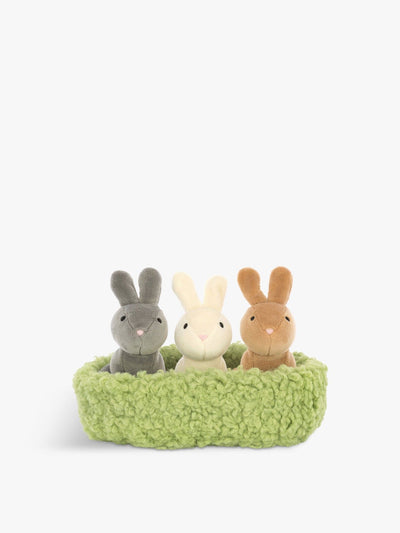 Three stuffed bunnies in a green nest