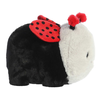 A red plush ladybug with black spots and a smiley face.