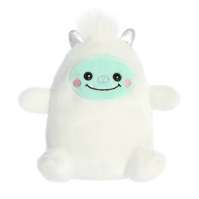 White plush creature with a friendly smile, pointed ears, and a curly tail. It has two small horns on its head.