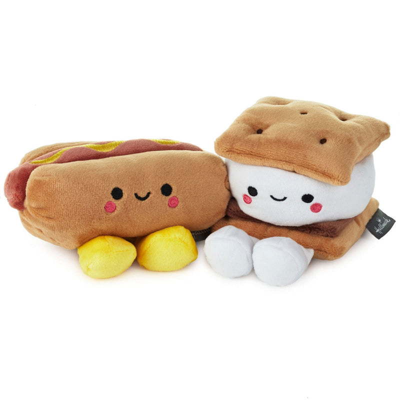 Two colorful plush toys magnetically connected. One plush is shaped like a hot dog and the other is a s&