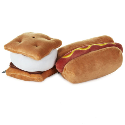 Two colorful plush toys magnetically connected. One plush is shaped like a hot dog and the other is a s'more.
