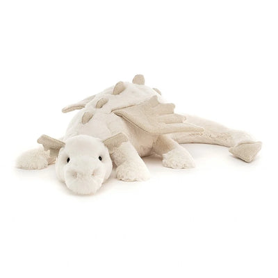 White stuffed dragon with wings on white background.