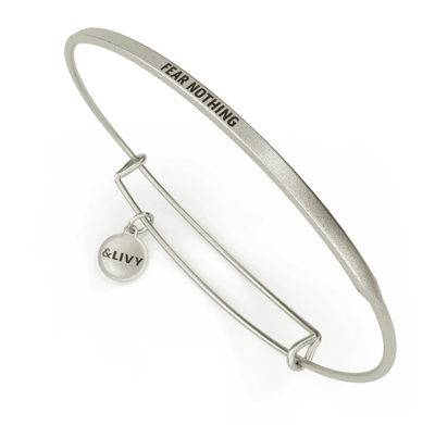 Silver bangle bracelet with the inspirational message “FEAR NOTHING” engraved on it.