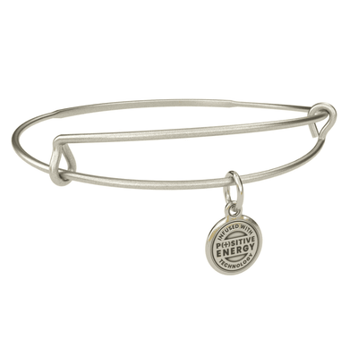 Silver bangle bracelet with a charm shaped like a four-leaf clover. The clover has a small, green stone in the center