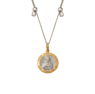 Women’s gold necklace with a small, intricate pendant in the shape of a dreamcatcher.
