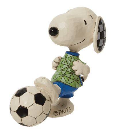 Small dog statue kicking a ball