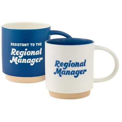 Two mugs stacked together. The top mug reads “Assistant to the Regional Manager” and the bottom mug reads “Regional Manager