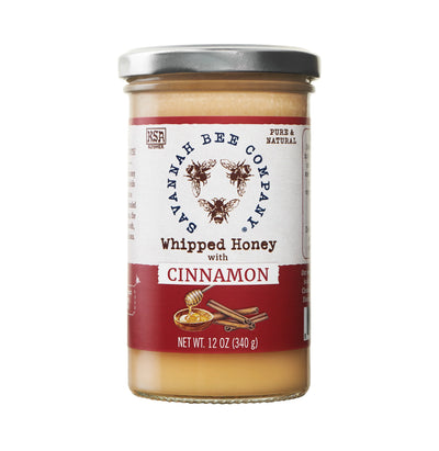 Jar of whipped honey with cinnamon label on white background