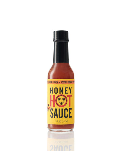 Bottle of Savannah Bee Company Honey Hot Sauce on white background