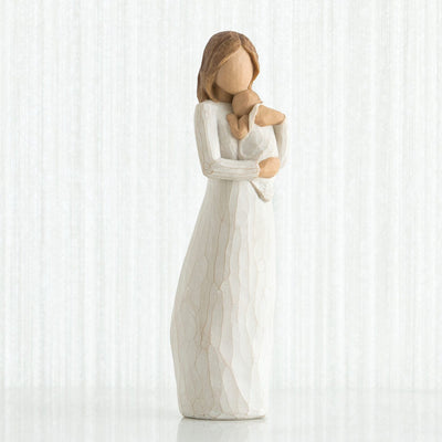 Angel of Mine - Willow Tree with in a cream dress, holding an infant in a cream blanket to her chest