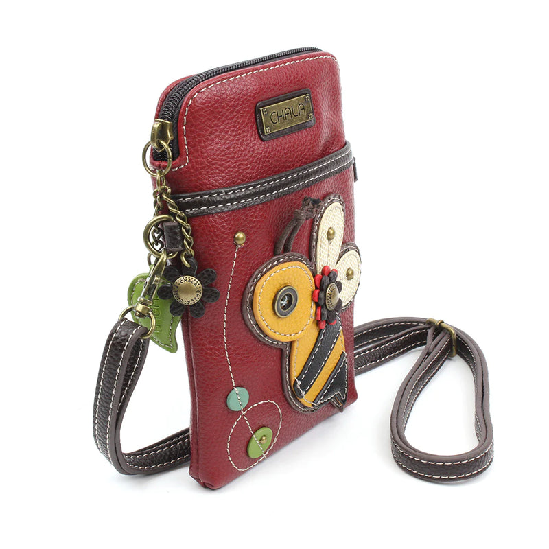 Red purse with gold bee on front flap closure. Detachable crossbody strap