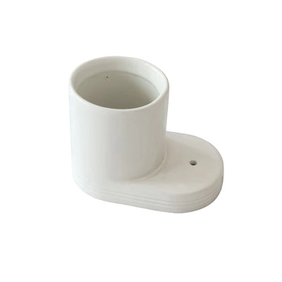 White ceramic coffee cup on white table
