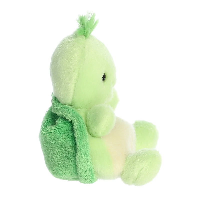 Small green plush turtle sitting in plaid armchair.