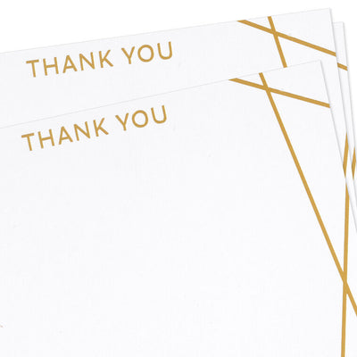 Flat white thank-you cards with intersecting gold foil lines and minimalist “thank you” message.

