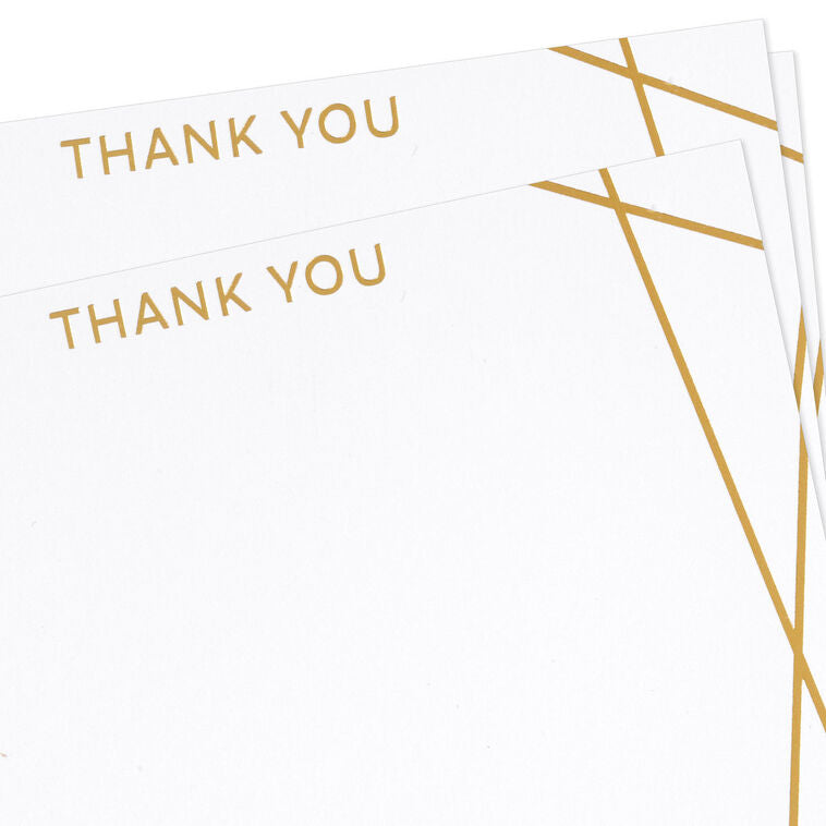 Flat white thank-you cards with intersecting gold foil lines and minimalist “thank you” message.
