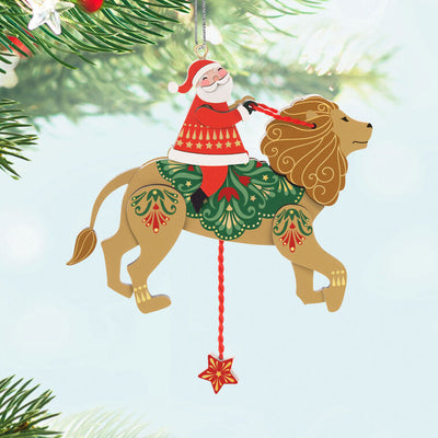 Wooden pull-string ornament of Santa riding a lion with moving reins and legs, inspired by jumping jack toys