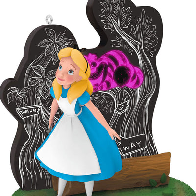 Alice stands in Wonderland before a glowing tree as the Cheshire Cat fades in and out in this Hallmark Keepsake Disney ornament.