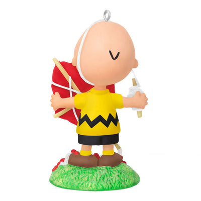 Mini Charlie Brown ornament tangled in red kite string, celebrating 75th anniversary, Hallmark Peanuts Christmas collectible
