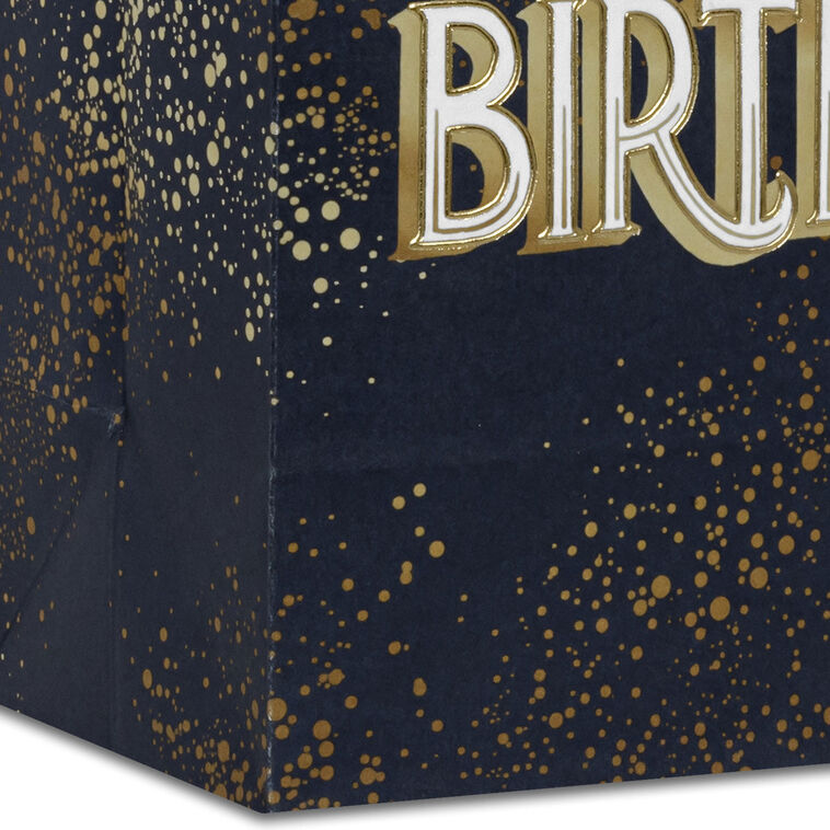 Small Hallmark gift bag with “Happy Birthday” in bold white and gold foil lettering on a navy blue background with gold splatter detail.