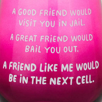Dark berry-tinted stemless wine glass with white text: “A good friend would visit you in jail.