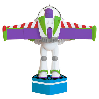 Buzz Lightyear Christmas ornament with wings extended on blue base, featuring light and sound effects