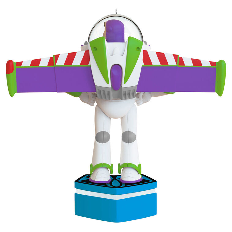 Buzz Lightyear Christmas ornament with wings extended on blue base, featuring light and sound effects
