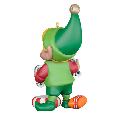 Hallmark Keepsake North Pole Tree Trimmers ornament—Santa’s elf holding old-fashioned ribbon candy, surrounded by hard candies, green hat and red suit
