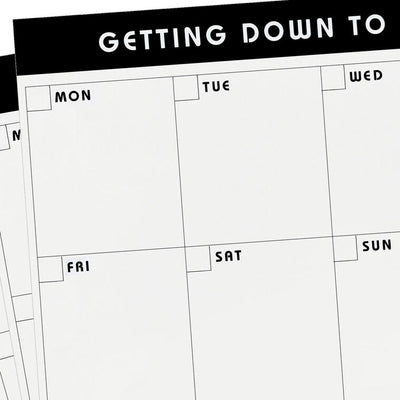 Large black and white weekly planner pad with grid layout and “Getting Down to Business” header.
