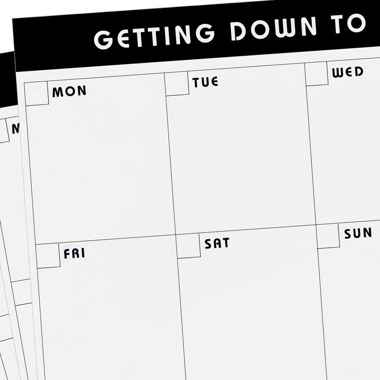 Large black and white weekly planner pad with grid layout and “Getting Down to Business” header.
