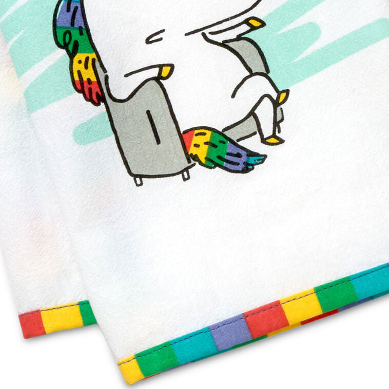 White cotton tea towel with rainbow-striped border and unicorn in chair, featuring the message: “You magical bastard.”