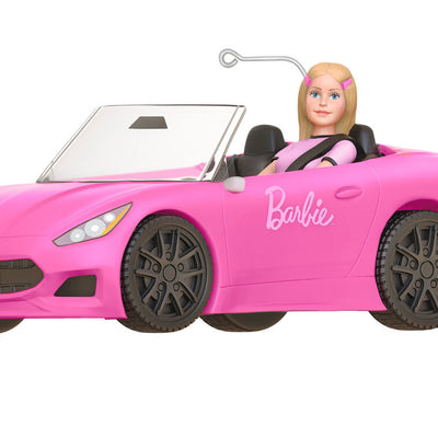 Barbie ornament driving a pink convertible sports car, wearing pink tee and barrettes, Hallmark Keepsake holiday decoration.