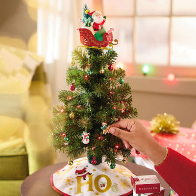 Vintage-style Santa in red sleigh with gifts and lighted base, part of ShowToppers musical tree topper system with synchronized effects.