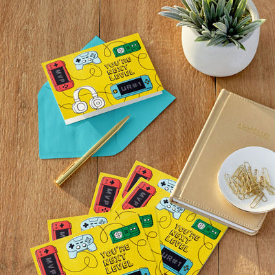 Fun Hallmark blank note cards with video game controllers and cords on a bright yellow background, boxed set of 10 with envelopes.
