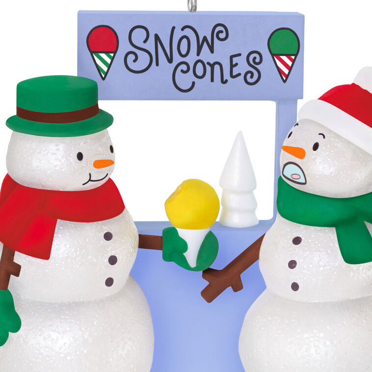 Humorous snowman Christmas ornament offering yellow snow cone to surprised snowperson