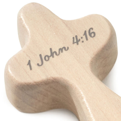 Hallmark mini comfort cross with gray heart design and I John 4:16 Bible verse on light wood.