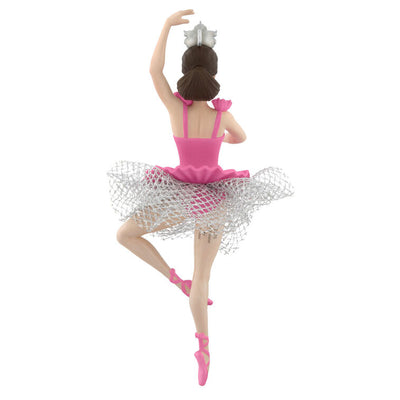 Barbie ballerina Christmas ornament wearing a pink tutu, pointe shoes, and silver tiara, posed en pointe with arm raised in a graceful ballet position.