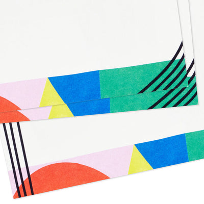 Flat note cards with colorful geometric border design and black parallel lines on white cardstock, wrapped in kraft band.

