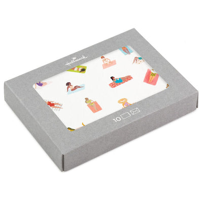 Blank note cards with retro-style illustrations of women sunbathing on colorful beach towels, boxed with envelopes.
