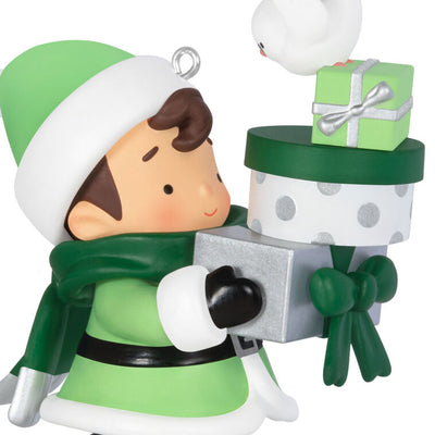 Mystery ornament featuring Young Santa in festive outfit holding presents and a bird, blind-boxed surprise