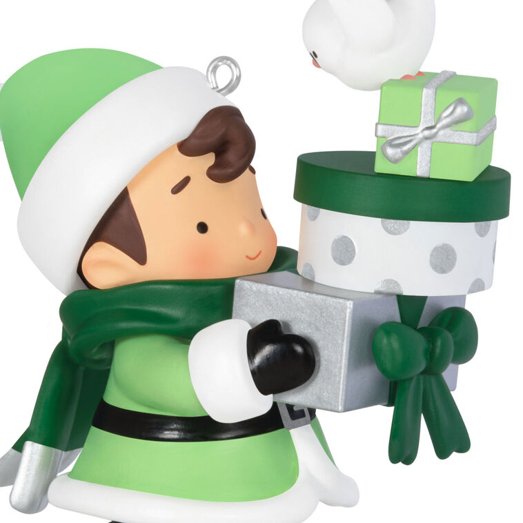 Mystery ornament featuring Young Santa in festive outfit holding presents and a bird, blind-boxed surprise