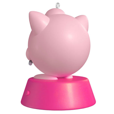 Hallmark Keepsake Pokémon Jigglypuff ornament, pink and round, singing into green microphone, with sound, on pink base.