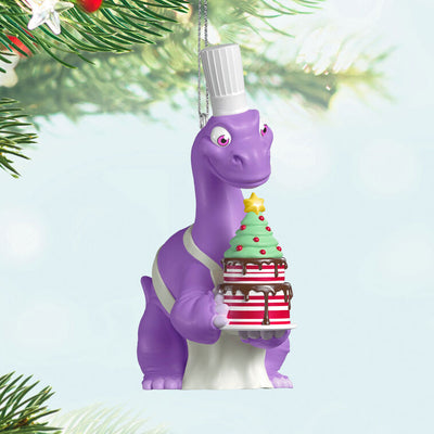 Purple Brachiosaurus in chef’s hat and apron holds a candy cane cake in this festive Hallmark Keepsake Christmas dinosaur ornament.