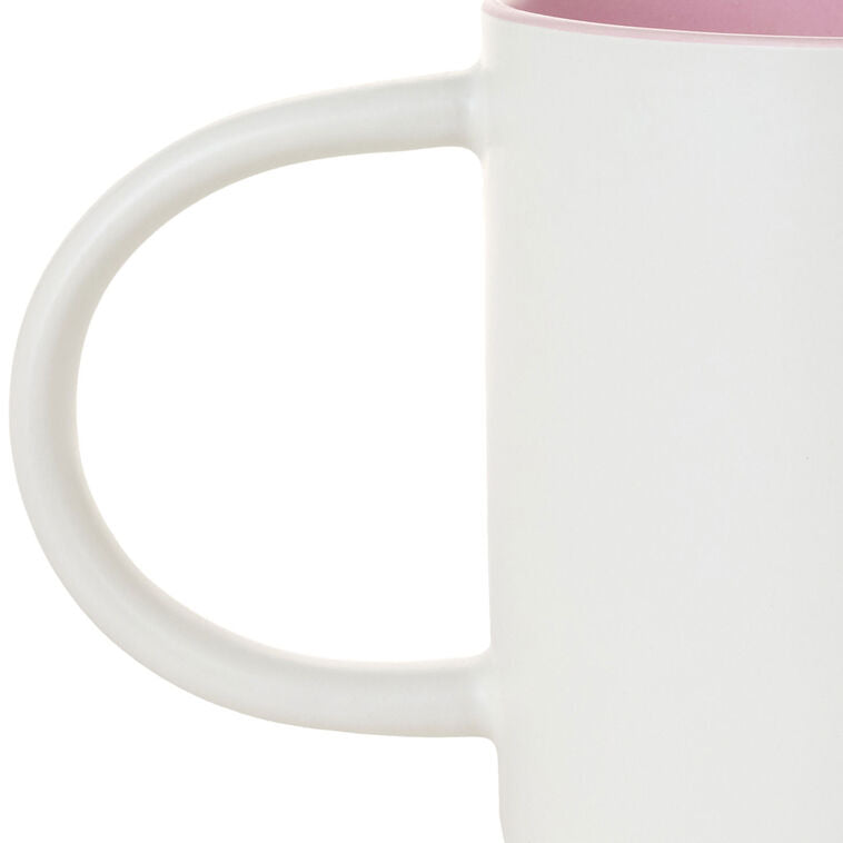 White ceramic mug with “Mom Sweet Mom” in colorful cross-stitch-style lettering and floral accents, oversized handle.