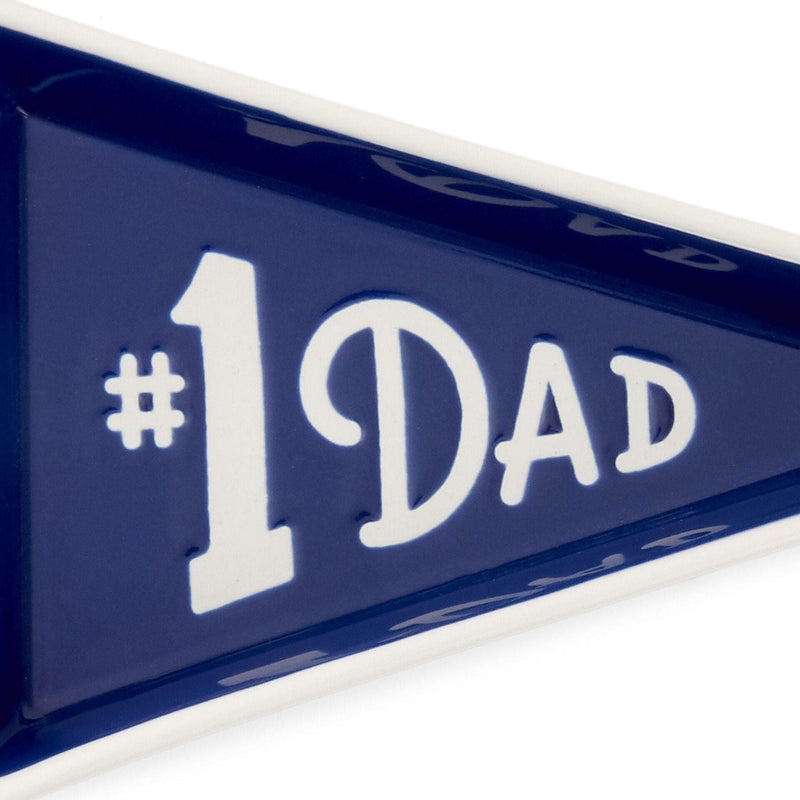 Pennant-shaped ceramic trinket tray with navy blue glaze and white "