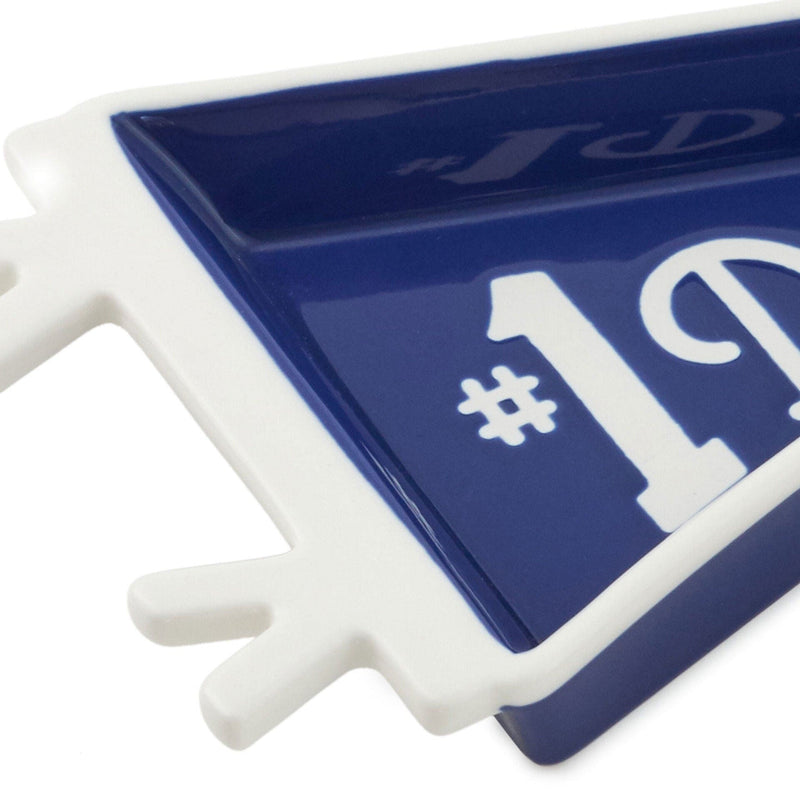 Pennant-shaped ceramic trinket tray with navy blue glaze and white "