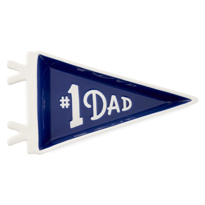 
Pennant-shaped ceramic trinket tray with navy blue glaze and white "#1 Dad" message and tie-themed trim.

