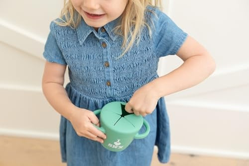 I Love SNX Happy Snacker silicone snack cup with snap-tight lid and easy-grip handles, designed for self-feeding.