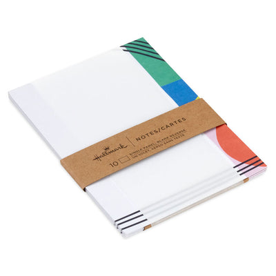 Flat note cards with colorful geometric border design and black parallel lines on white cardstock, wrapped in kraft band.
