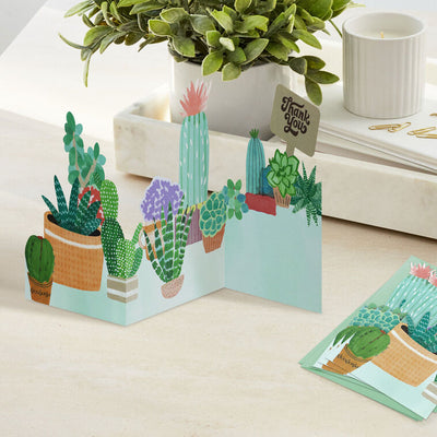 Die-cut thank-you cards with fold-out illustrated potted succulents and cacti in display-ready shapes.
