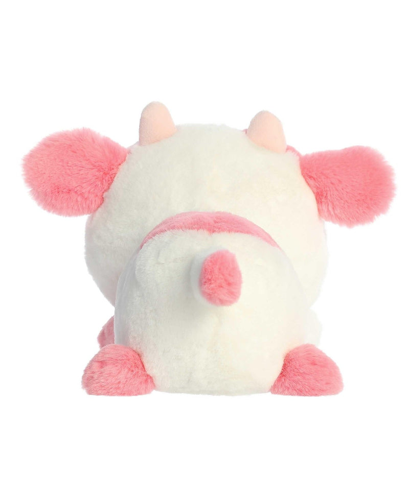 Katelyn Cow plush by Aurora in white and pink, lying belly-down with sparkling eyes and a heart-shaped nose for Valentine&